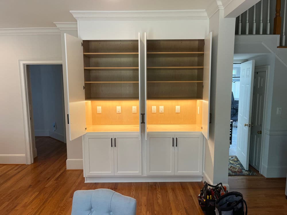 Modern built-in cabinetry with open shelves and recessed lighting in a bright room.
